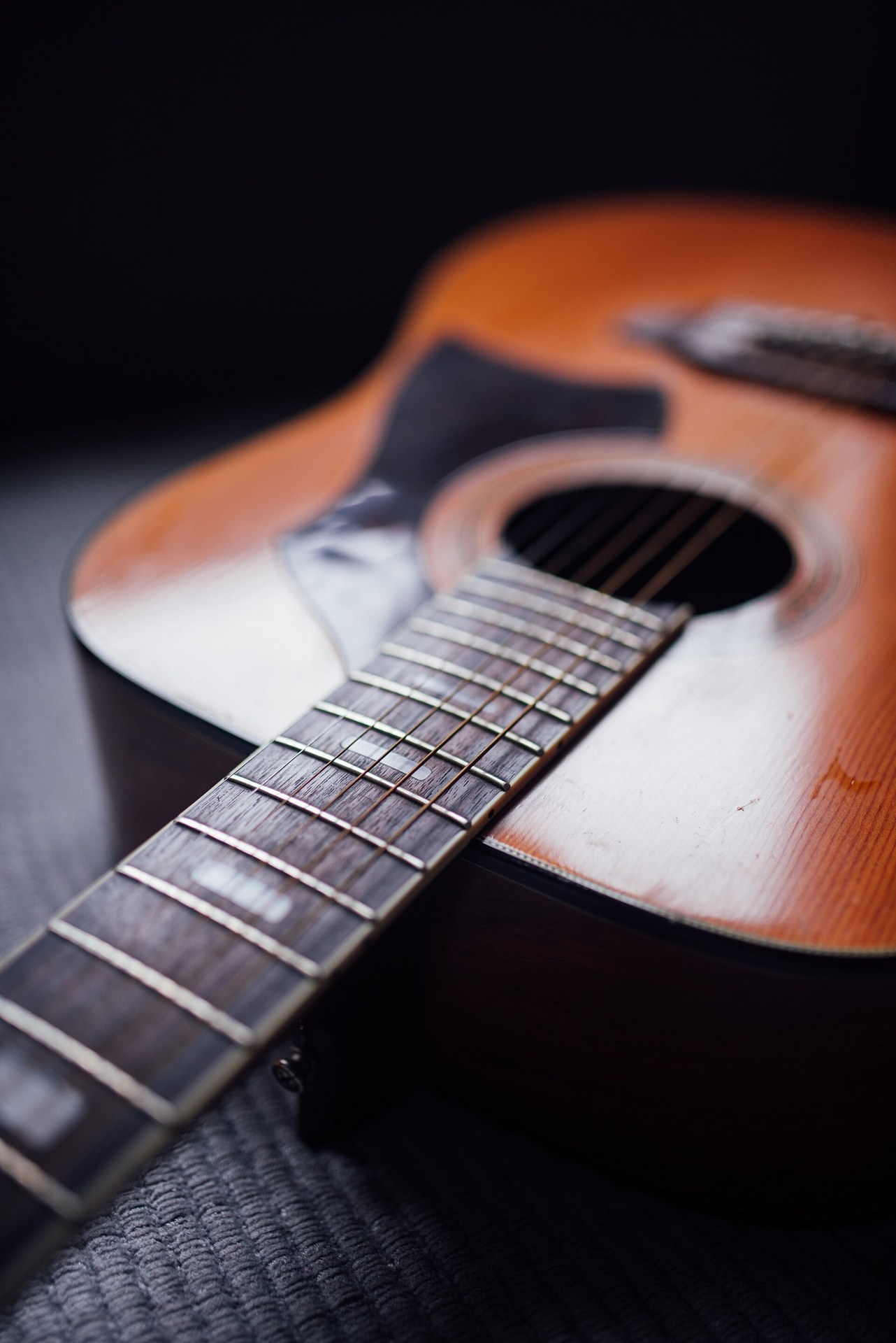 Close-up of the strings and body of an acoustic guitar